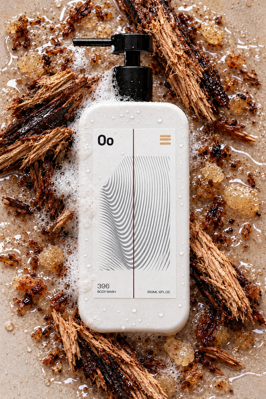 Oo La Lab Grounding 396 body wash among wet aromatic wood and resin, with its embossed label and gold foil icon visible